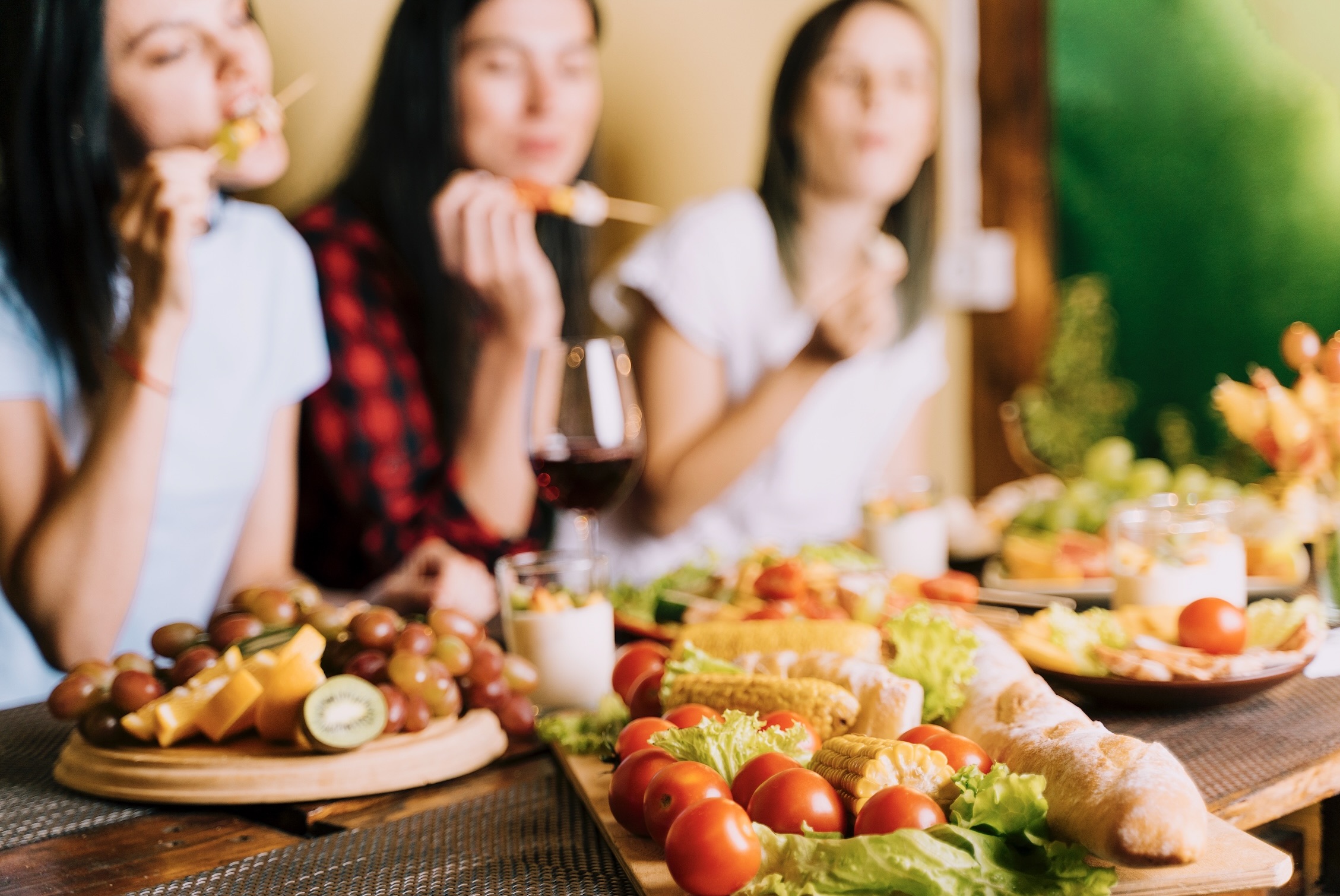 People eating appetizers. Blurred background.